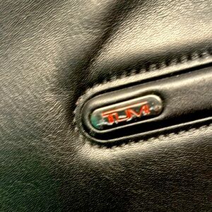 TUMI black leather messenger bag in used but great condition